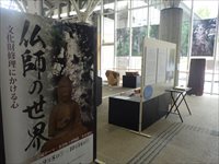 仏師の世界と書かれた入口のポスター横から中の展示を写している写真