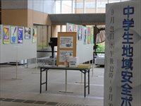 パーテーションにカラフルのポスターが貼られている様子を入口のパネル横から写した写真