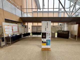 展示スペースに設置されたパネル展示と中央の案内スタンドの写真