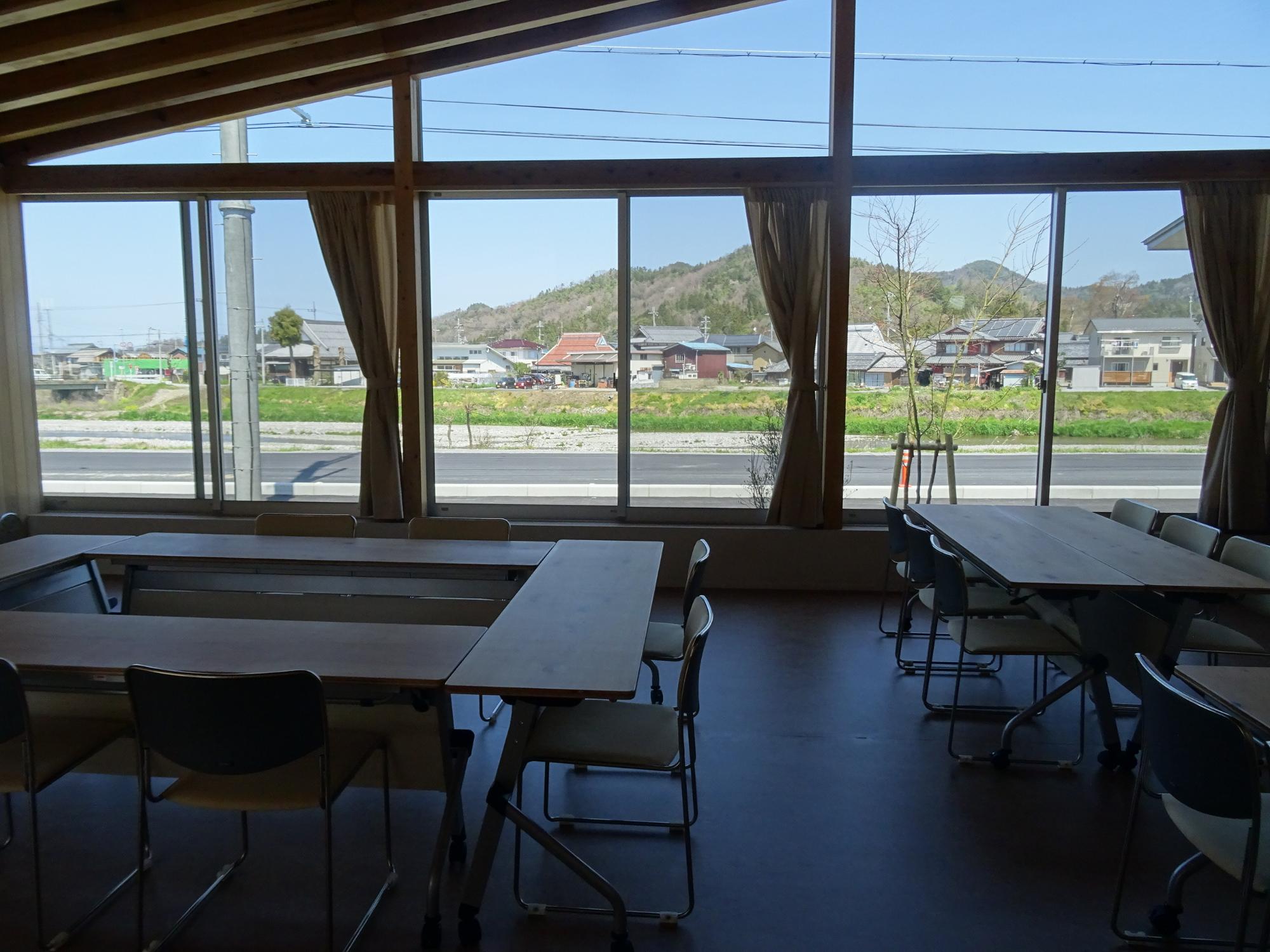 大きな窓から外の景色が見える木造建築の会議室の写真