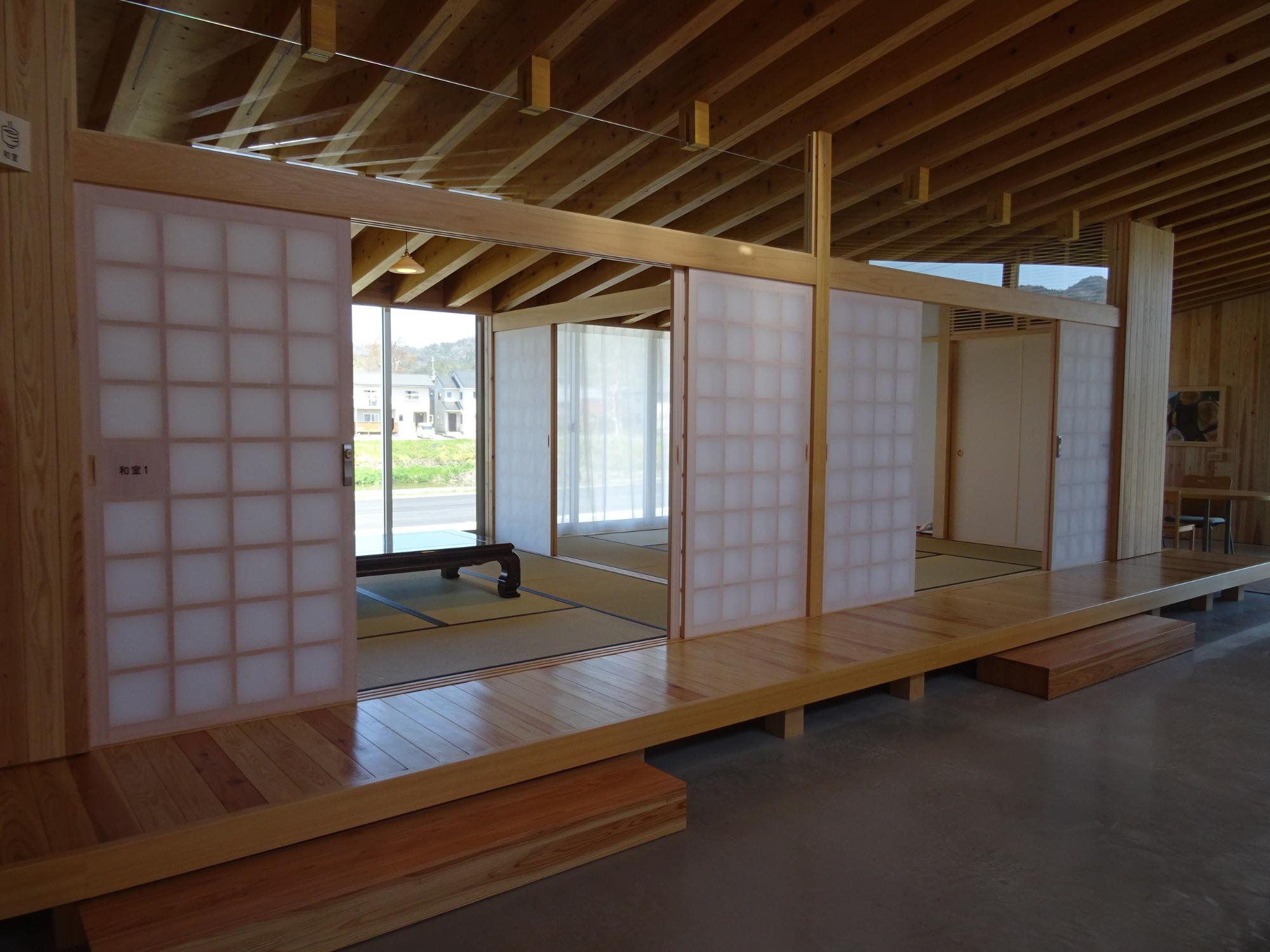 障子戸で仕切られた畳敷きの和室が並ぶ空間を斜めから写した写真